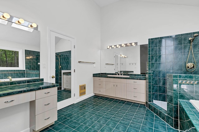 20A Bush Hill Dr, East Lyme, CT 06357 - full bathroom featuring two vanities, tile patterned floors, heating unit, a tile shower, and tiled bath