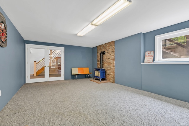 20A Bush Hill Dr, East Lyme, CT 06357 - unfurnished room featuring a wood stove and carpet flooring