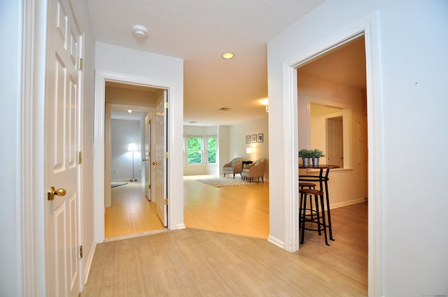 15 Highland St Apt 106, West Hartford, CT 06119 - hallway featuring light wood-type flooring, baseboards, and recessed lighting
