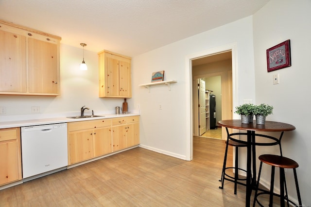 15 Highland St Apt 106, West Hartford, CT 06119 - kitchen with white dishwasher, light brown cabinetry, a sink, light countertops, and baseboards