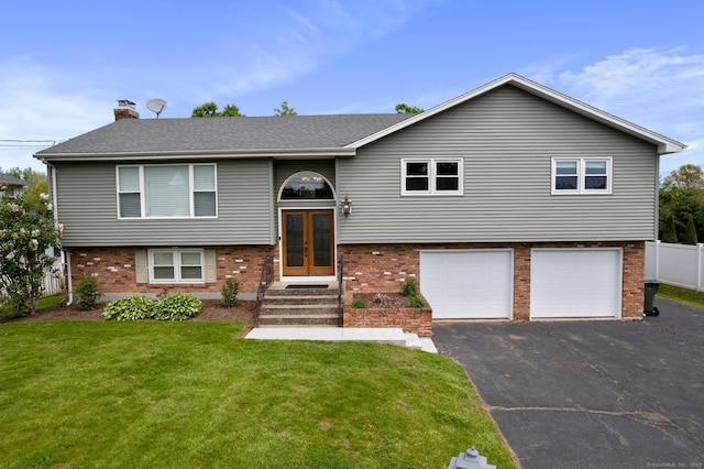 104 Willow St, Wethersfield, CT 06109 - raised ranch featuring french doors, brick siding, an attached garage, a front lawn, and driveway