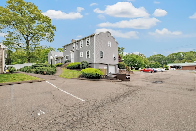 view of front of property featuring uncovered parking and a chimney