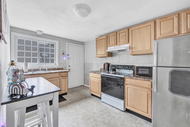 kitchen with freestanding refrigerator, white electric range oven, under cabinet range hood, light brown cabinets, and black microwave