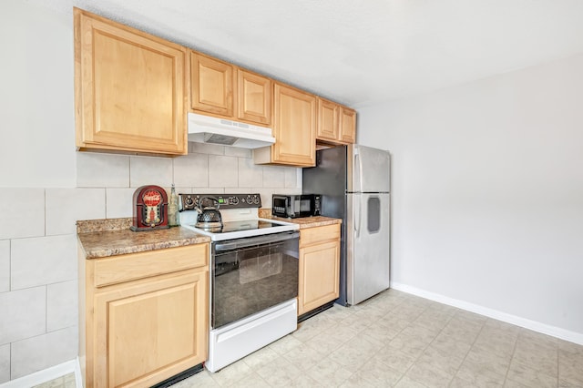 kitchen with white range with electric stovetop, under cabinet range hood, light brown cabinets, and freestanding refrigerator