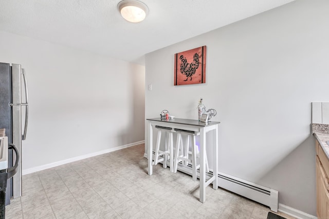 interior space featuring light flooring and baseboards