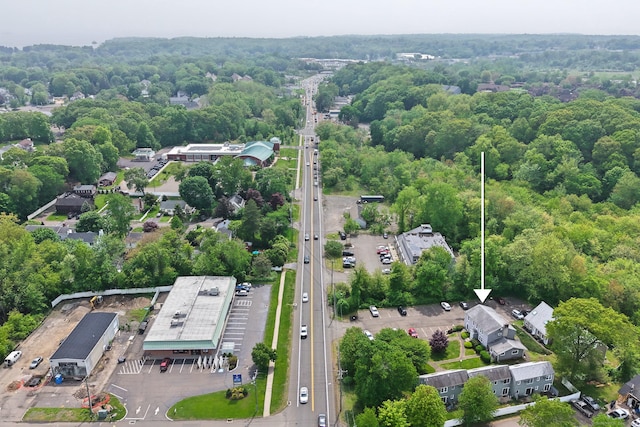 aerial view of property and surrounding area featuring property parcel outlined and a forest