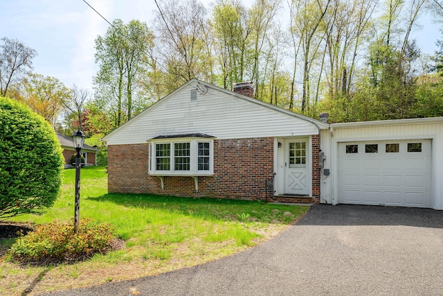 3 Lambert Ln Unit 3, Brookfield, CT 06804 - view of front of house featuring a chimney, brick siding, an attached garage, asphalt driveway, and a front yard