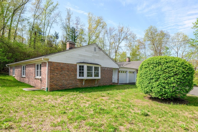 3 Lambert Ln Unit 3, Brookfield, CT 06804 - view of home's exterior with a chimney, an attached garage, brick siding, and a yard