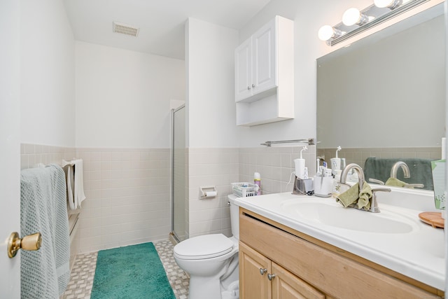 3 Lambert Ln Unit 3, Brookfield, CT 06804 - bathroom featuring tile walls, vanity, a shower stall, toilet, and wainscoting