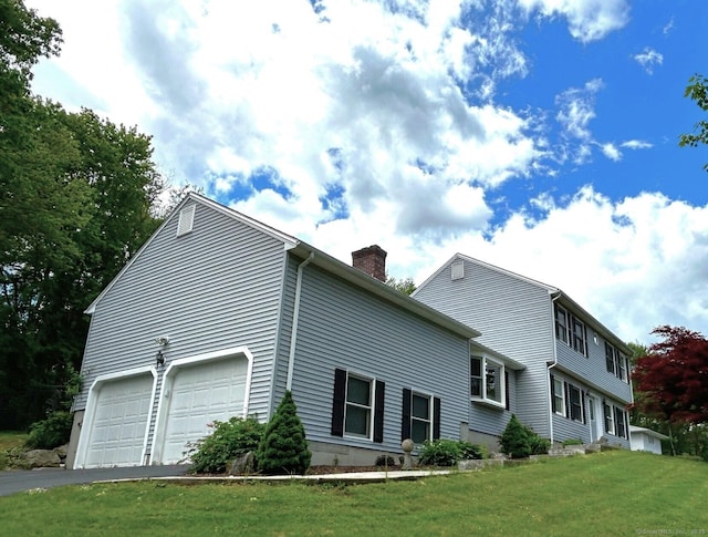 397 Walnut Hill Rd, Thomaston, CT 06787 - view of property exterior with a chimney, a lawn, driveway, and an attached garage