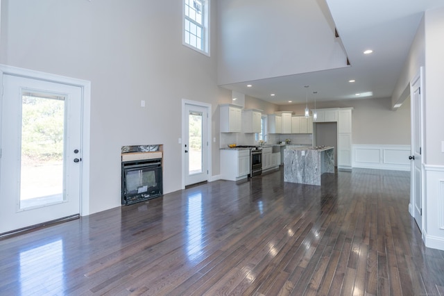 2 Stratton Farms Rd, Suffield, CT 06093 - unfurnished living room featuring dark wood-type flooring and a towering ceiling