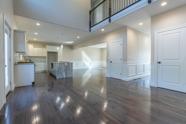 2 Stratton Farms Rd, Suffield, CT 06093 - unfurnished living room featuring wainscoting, a decorative wall, dark wood-style floors, and recessed lighting