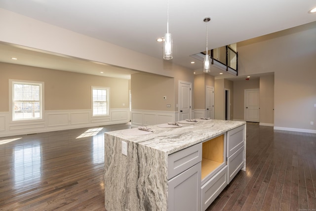 2 Stratton Farms Rd, Suffield, CT 06093 - kitchen with open floor plan, dark wood-style flooring, wainscoting, pendant lighting, and a center island
