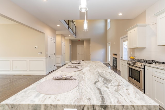2 Stratton Farms Rd, Suffield, CT 06093 - kitchen with stainless steel range with gas cooktop, white cabinets, a large island, and recessed lighting