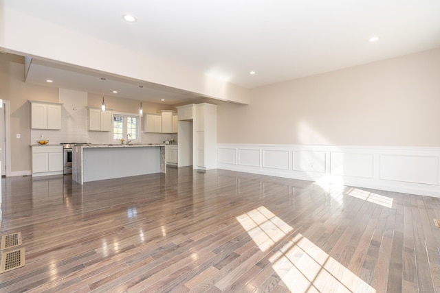 2 Stratton Farms Rd, Suffield, CT 06093 - unfurnished living room featuring wood finished floors, wainscoting, and recessed lighting