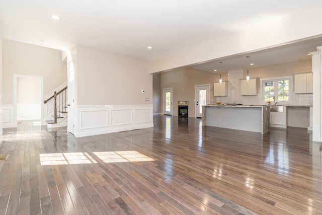 2 Stratton Farms Rd, Suffield, CT 06093 - unfurnished living room featuring wainscoting, stairway, wood finished floors, a decorative wall, and recessed lighting