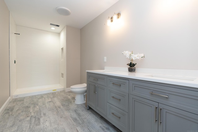 2 Stratton Farms Rd, Suffield, CT 06093 - bathroom with toilet, tiled shower, wood finished floors, vanity, and baseboards