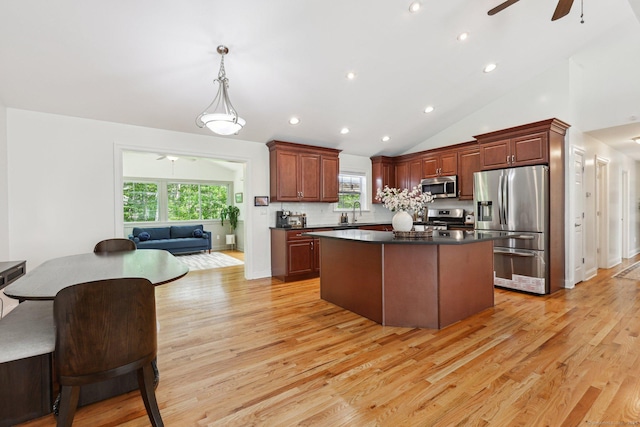 2 Red Fox Run, Wolcott, CT 06716 - kitchen featuring stainless steel appliances, a ceiling fan, dark countertops, a center island, and light wood-style flooring