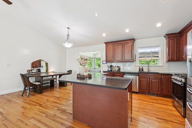 2 Red Fox Run, Wolcott, CT 06716 - kitchen featuring stainless steel appliances, dark countertops, a sink, decorative backsplash, and light wood finished floors