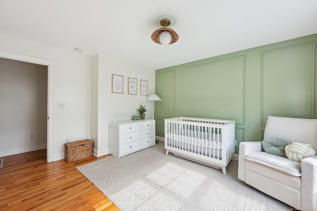 2 Red Fox Run, Wolcott, CT 06716 - bedroom featuring light wood-type flooring, baseboards, and a decorative wall