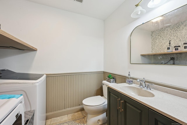 2 Red Fox Run, Wolcott, CT 06716 - bathroom with washer and dryer, wainscoting, vanity, toilet, and tile patterned floors