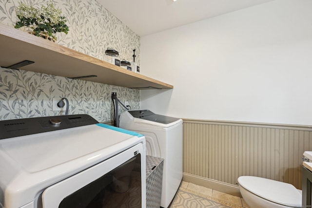 2 Red Fox Run, Wolcott, CT 06716 - laundry area featuring washing machine and dryer, a wainscoted wall, wallpapered walls, and light tile patterned flooring