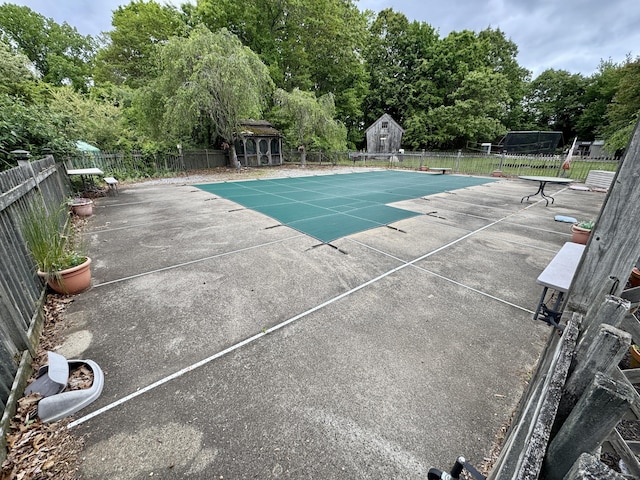 23 Old Mill Rd, Clinton, CT 06413 - view of pool with a patio, an outbuilding, a diving board, and view of wooded area
