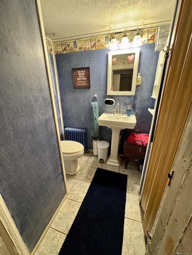 23 Old Mill Rd, Clinton, CT 06413 - bathroom with radiator heating unit, toilet, a textured ceiling, and tile patterned floors