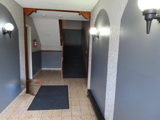 110 Bond St Unit 5B, Hartford, CT 06114 - hall featuring stairs, a textured wall, and arched walkways