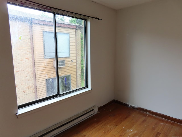 110 Bond St Unit 5B, Hartford, CT 06114 - empty room featuring a baseboard radiator, wood finished floors, and baseboards