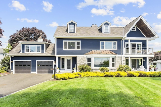 190 Bayview Blvd, Stratford, CT 06615 - view of front of property with asphalt driveway, a front yard, a garage, stone siding, and a balcony