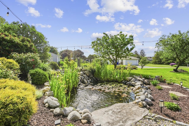 190 Bayview Blvd, Stratford, CT 06615 - view of green lawn with a small pond and a garage