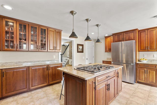 190 Bayview Blvd, Stratford, CT 06615 - kitchen with stainless steel appliances, glass insert cabinets, brown cabinets, recessed lighting, and decorative light fixtures