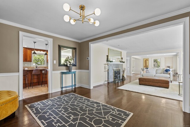 190 Bayview Blvd, Stratford, CT 06615 - entryway featuring wood finished floors, a chandelier, crown molding, and a tiled fireplace