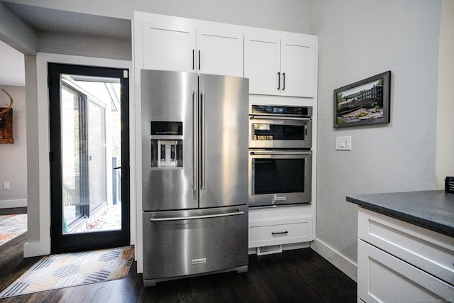 8 Bruce Ln, Avon, CT 06001 - kitchen with stainless steel appliances, dark wood-style flooring, baseboards, and white cabinetry