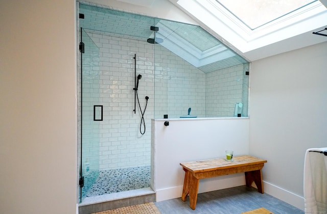 8 Bruce Ln, Avon, CT 06001 - bathroom featuring a skylight, a stall shower, baseboards, wood finished floors, and vaulted ceiling