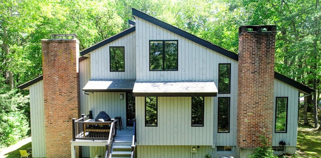 8 Bruce Ln, Avon, CT 06001 - view of front of property with a chimney, roof with shingles, and a deck