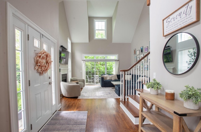 78 Copper Square Dr Unit 78, Bethel, CT 06801 - entryway featuring a towering ceiling, stairway, hardwood / wood-style flooring, and a fireplace
