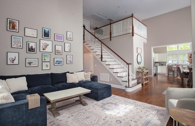 78 Copper Square Dr Unit 78, Bethel, CT 06801 - living area with a towering ceiling, wood finished floors, stairway, and baseboards