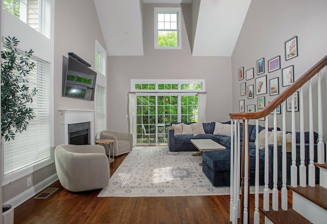 78 Copper Square Dr Unit 78, Bethel, CT 06801 - living area with a high ceiling, wood finished floors, stairs, a fireplace, and baseboards