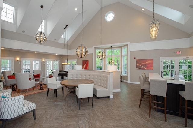 78 Copper Square Dr Unit 78, Bethel, CT 06801 - living area with a chandelier, high vaulted ceiling, a skylight, baseboards, and french doors