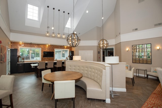 78 Copper Square Dr Unit 78, Bethel, CT 06801 - dining area featuring a chandelier, high vaulted ceiling, baseboards, plenty of natural light, and a skylight