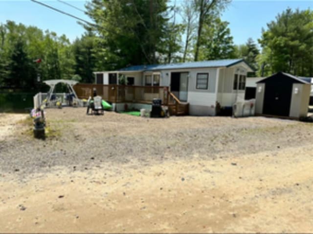8 S Rd Unit W86, Stafford, CT 06076 - manufactured / mobile home with a storage unit and an outdoor structure