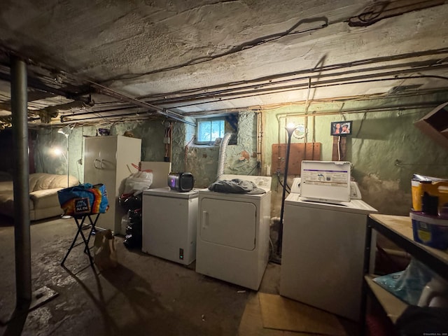 basement featuring independent washer and dryer and fridge