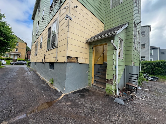view of side of property featuring entry steps