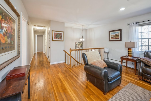 90 Akbar Rd, Stamford, CT 06902 - sitting room with attic access, an upstairs landing, light wood-style floors, recessed lighting, and baseboards