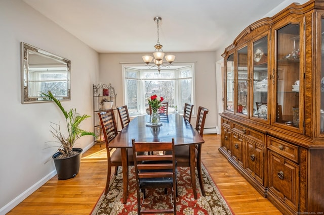90 Akbar Rd, Stamford, CT 06902 - dining room featuring a chandelier, baseboards, and light wood finished floors