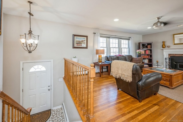 90 Akbar Rd, Stamford, CT 06902 - living room featuring a chandelier, light wood finished floors, ceiling fan, a baseboard radiator, and recessed lighting