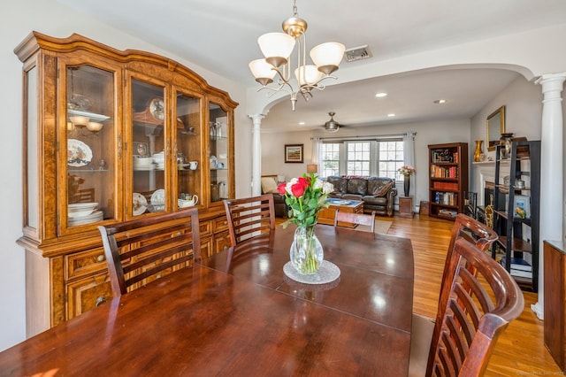 90 Akbar Rd, Stamford, CT 06902 - dining space with arched walkways, decorative columns, wood finished floors, and recessed lighting
