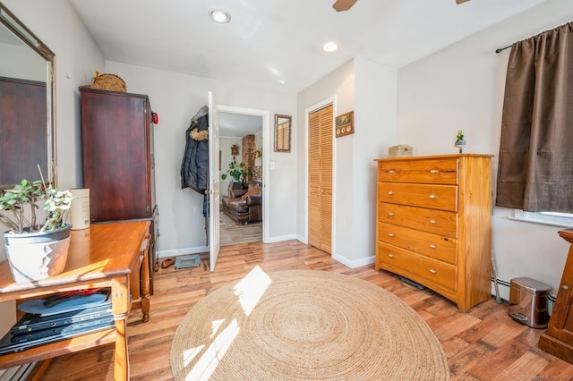 90 Akbar Rd, Stamford, CT 06902 - bedroom featuring light wood-style floors, a baseboard radiator, a closet, recessed lighting, and ceiling fan